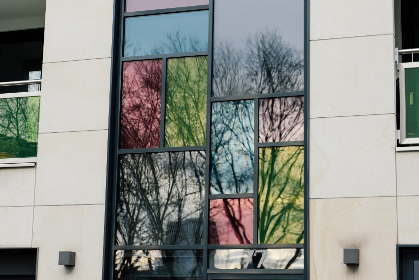 Colored window film on a modern building exterior by Pro Tint LLC in Palm Coast, FL